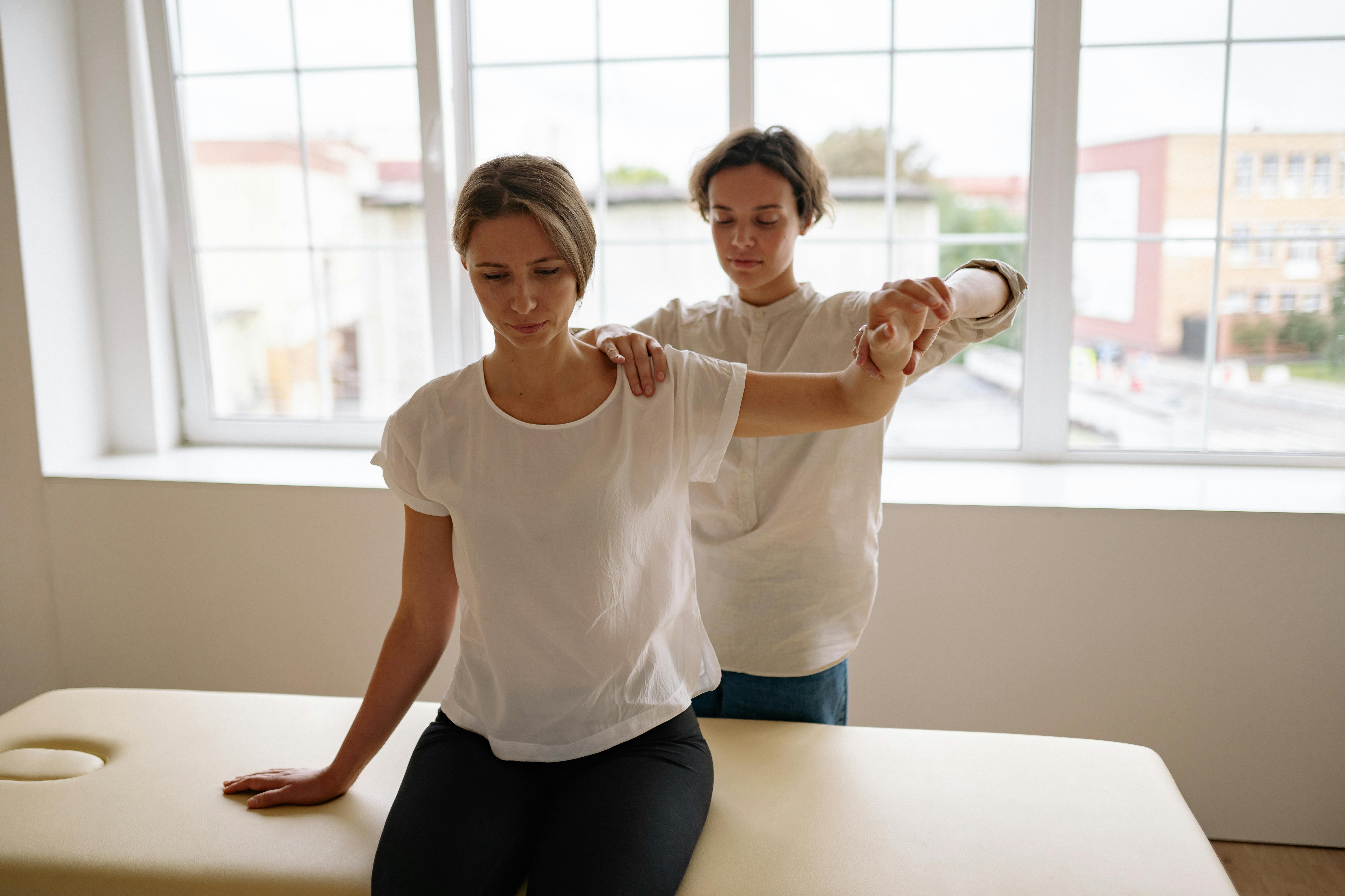 Therapists guiding patients through rehabilitative exercises